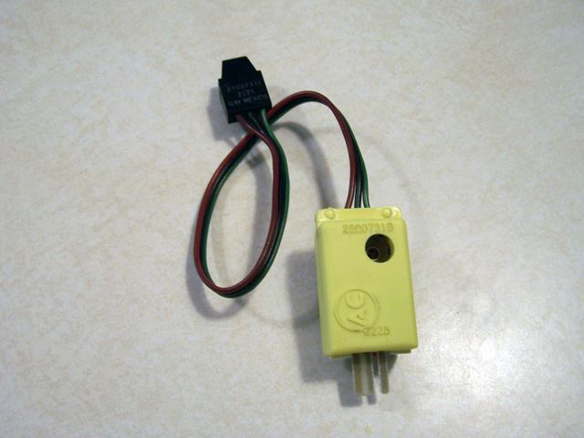 This is an optical buffer and optic head.  Often referred to as a Vehical Speed Sensor (VSS). This was the sensor GM used from 1982 to 1991.  This sensor has an infrared emitter and sensor in the optic head.  When the infrared light is reflected into the sensor the buffer creates a pulse to the engine control unit (ECU).