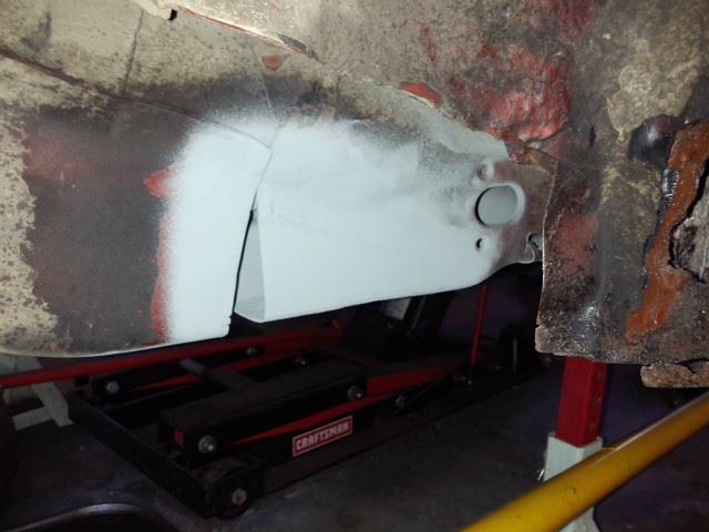 Welded in a patch for the torque box and filled the spot weld holes.  Coated with 2 coats of weld through primer.