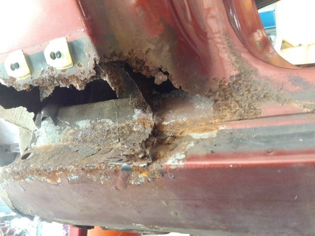 Part of the inner door jamb brace is gone and the last 6 inches of the rocker panel is badly rusted.