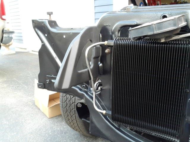 The trans cooler belongs on a 3/4 ton Chevy truck, so it should work nicely for a car.  There is 1/8" clearance between the tubing and the header brace.